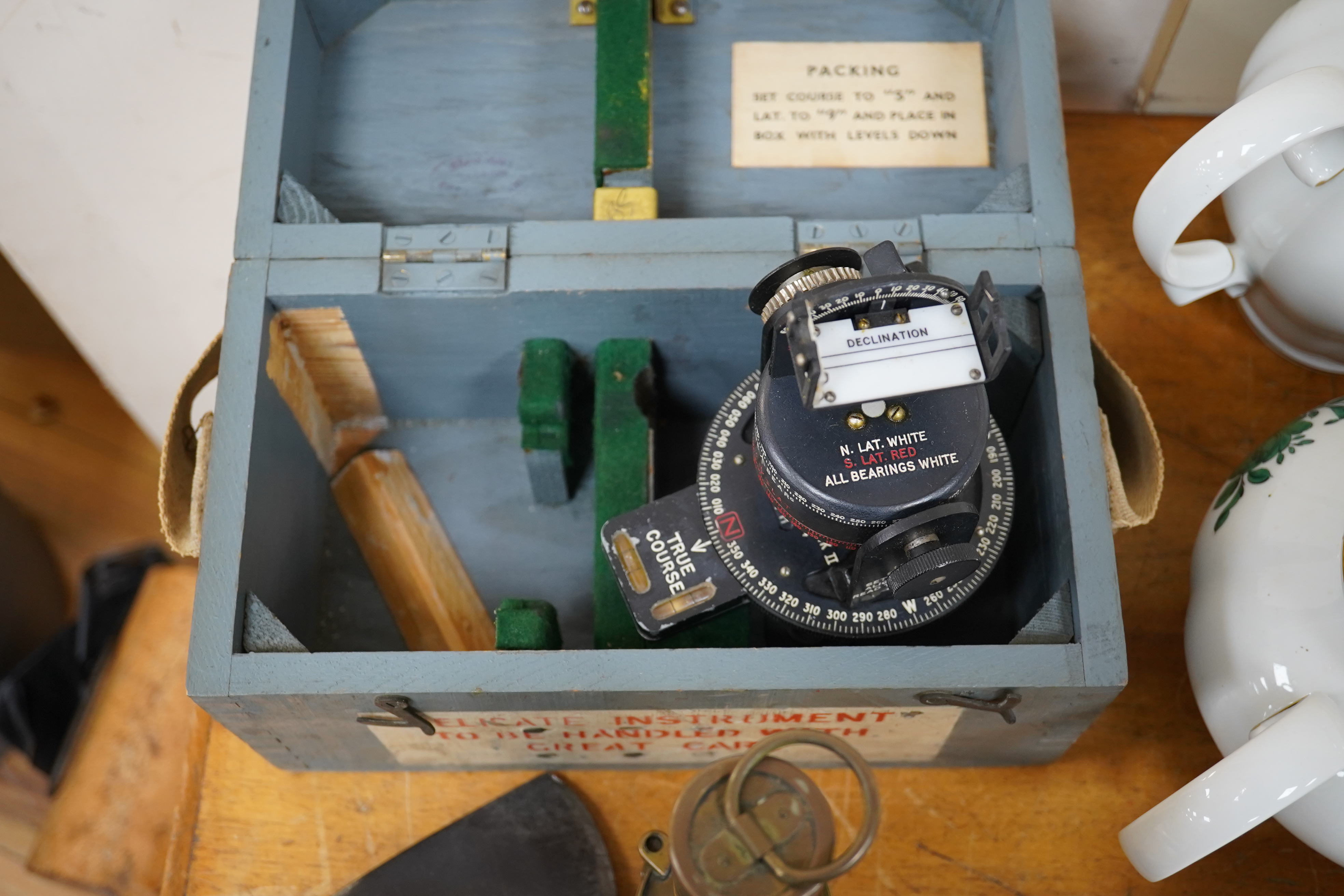 Two WWII RAF Air Ministry aircraft escape axes, one stamped; Elwell 1943, a cased Astro Compass Mk.II, and a brass Air Ministry signalling torch. Condition - fair to good.